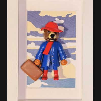 Tableau Paddington, figurine ours au chapeau et bottes rouges, manteau bleu et valise, cadre blanc 10x15 cm