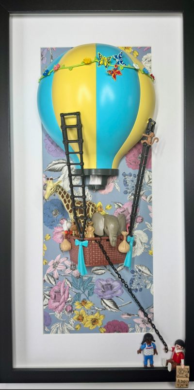Tableau J'AI RÊVÉ, montgolfière Playmobil jaune et bleue avec girafe, éléphant et singes sur fond fleuri