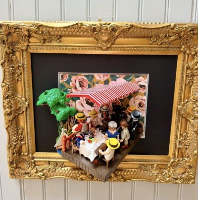 Tableau Le déjeuner des canotiers en figurines Playmobil sous un store rayé rouge et blanc, cadre doré ouvragé